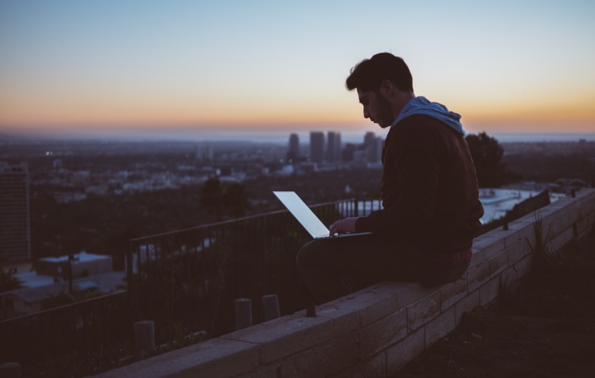 a man working on his laptop outside