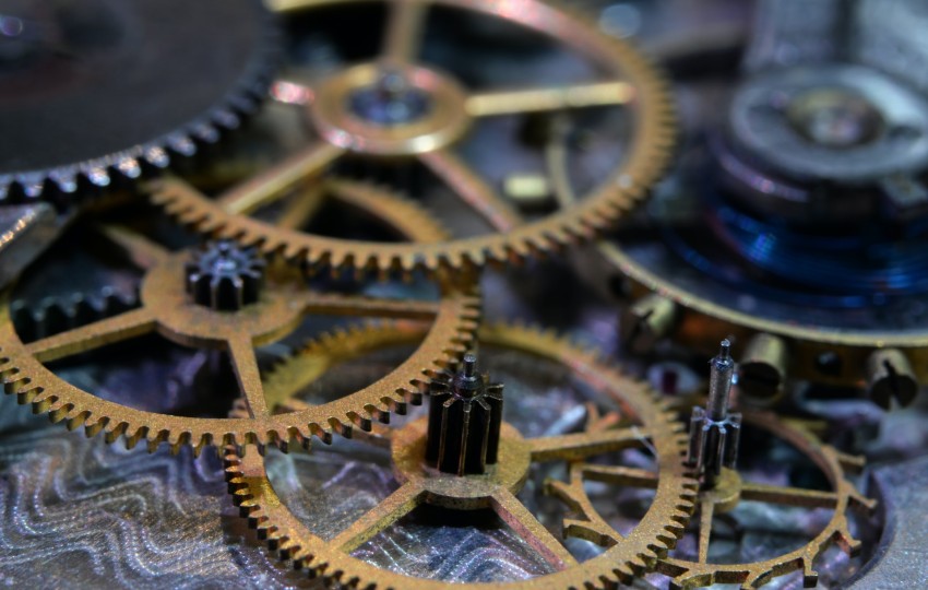 The cogs inside a clock word together