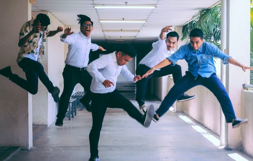 a group of young men jumping with joy