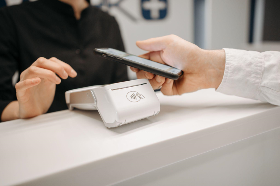 Someone using a POS to pay with their phones