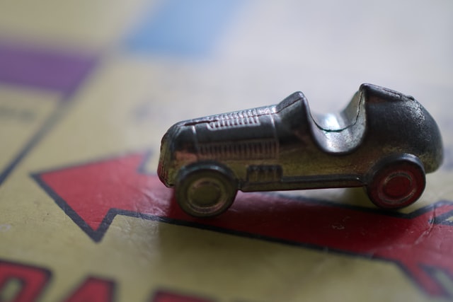 A monopoly car on top of the game