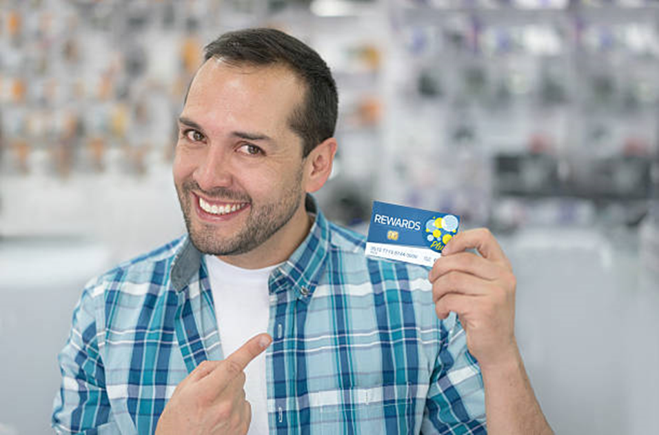 A customer smiles with his rewards card   and improves his relationship with your business.