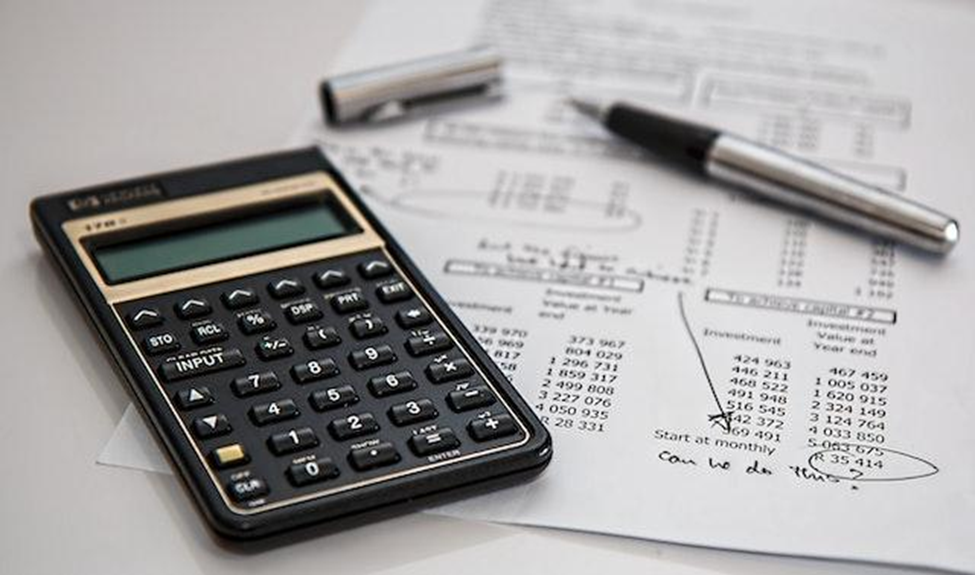 A black calculator and budget planning table