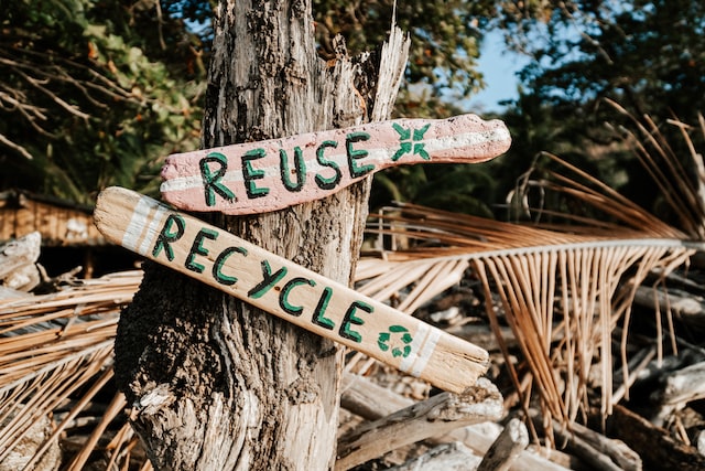 A wooden sign saying reuse,recycle.