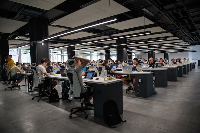 A call center full of people working on their desks.