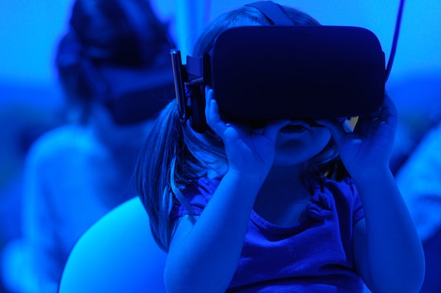 A girl plays an educational game while wearing a VR headset.