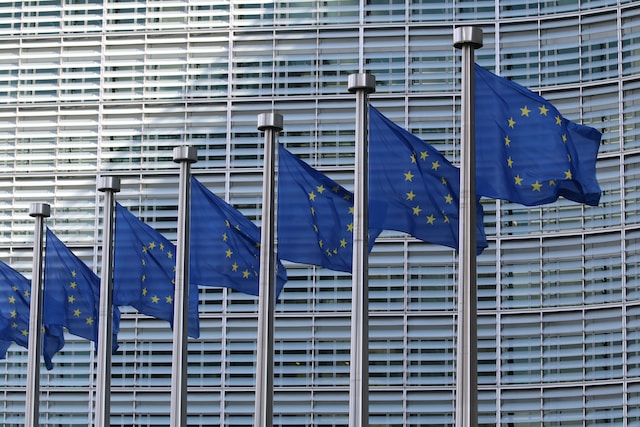 European flags outside the European parliament that sets the European regulatory environment.